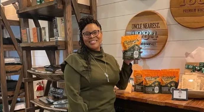 Dr. Penny Mickey, co-owner of Mickey’s Popcorn with one of their signature products.