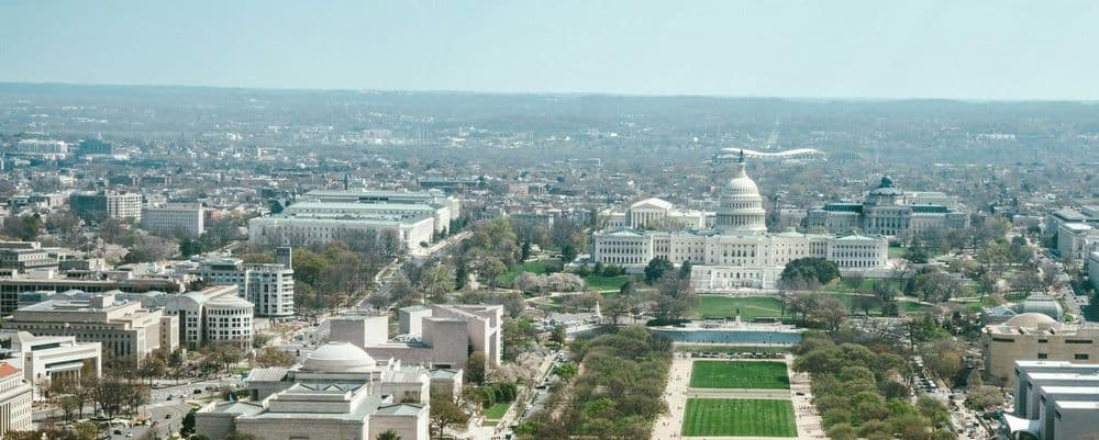 Aerial view of Washington D.C. featuring the U.S. Capitol Building and the National Mall.