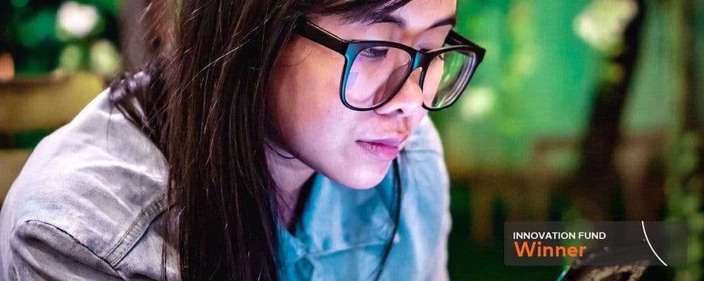 Person wearing glasses intensely focused on a screen, with 'Innovation Award Winner' text visible.