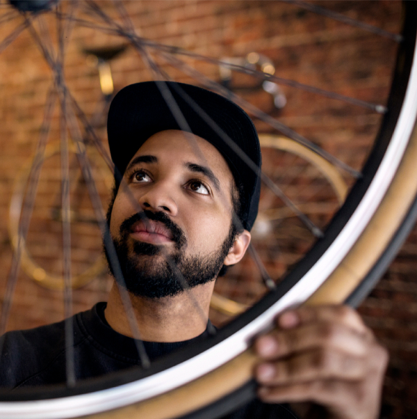 Man inspecting a bike wheel